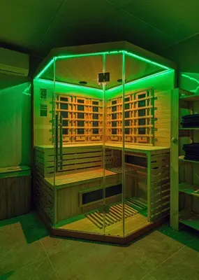 a large wooden cage with green lights in a room at Вила Звездопад in Manastir