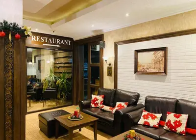 a lobby with a leather couch and a table at Studio with pool, SPA near the Ski Lift in Bansko