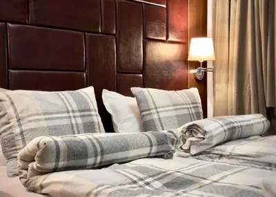 a bed with two pillows on top of it at Studio with pool, SPA near the Ski Lift in Bansko