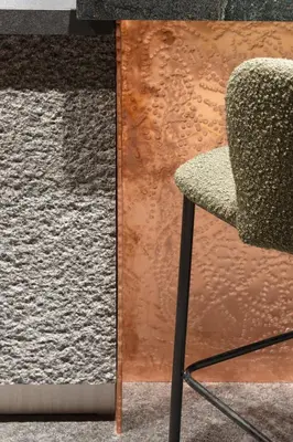 a chair sitting next to a wall with a rug at Flora Boutique Hotel in Borovets