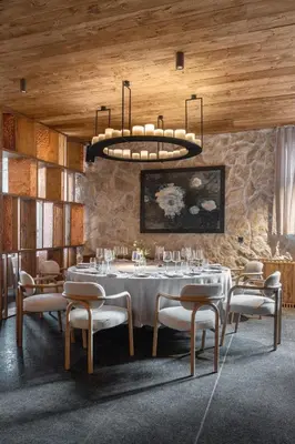 a dining room with a white table and chairs at Flora Boutique Hotel in Borovets