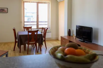 a living room with a table with a bowl of fruit at Predela Apartments with Spa in Bansko