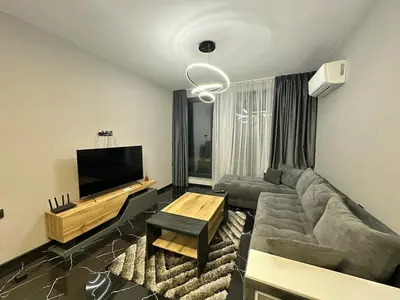 a living room with a couch and a flat screen tv at Diamond Casa with Free Private Parking in Plovdiv