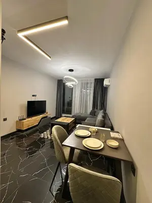 a living room with a table and a couch at Diamond Casa with Free Private Parking in Plovdiv