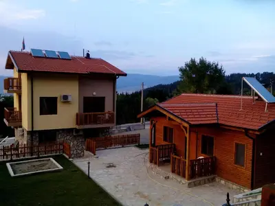 two houses with solar panels on the roofs at Mini Complex Rilski Terasi in Sapareva Banya