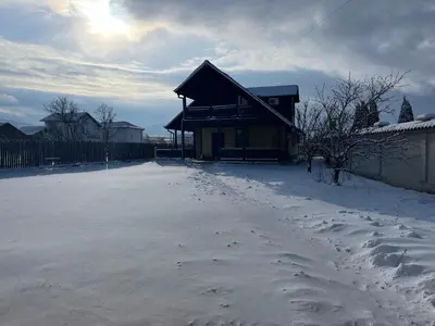 a house in the snow with footprints in the snow at Mountain Family Guest House Rayovo in Rayovo