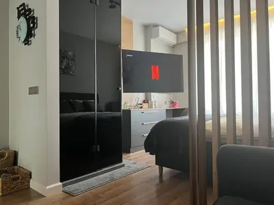 a bedroom with a tv and a bed and a mirror at 2-Bedroom Luxury Apartment in the center of Sofia in Sofia