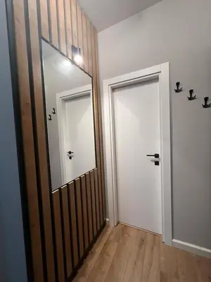 a hallway with a mirror and a white door at 2-Bedroom Luxury Apartment in the center of Sofia in Sofia