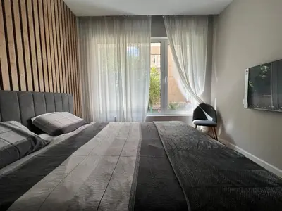a bedroom with a large bed and a window at 2-Bedroom Luxury Apartment in the center of Sofia in Sofia