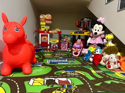 a group of stuffed animals and toys on a rug at Резиденция БАЛМОРА in Kalofer