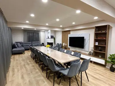 a living room with a large table and chairs at Резиденция БАЛМОРА in Kalofer