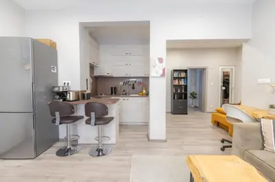 a kitchen and living room with a refrigerator and a couch at NDK - UrbanLux Medius 2BDR FREE Parking in Sofia