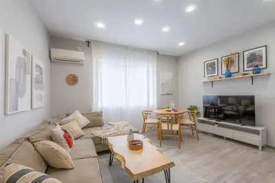 a living room with a couch and a table at NDK - UrbanLux Medius 2BDR FREE Parking in Sofia