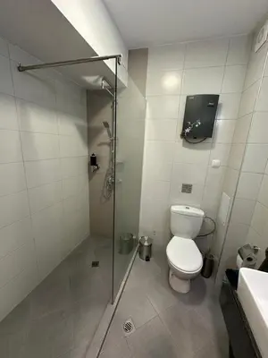 a bathroom with a shower and a toilet and a sink at Velingrad Prime 2-Bedroom Apartment in Velingrad