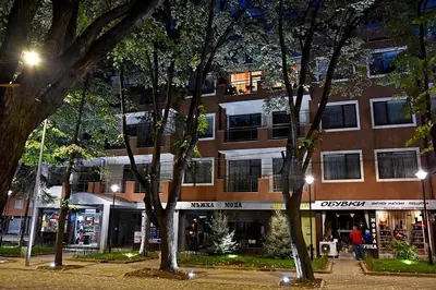 a building at night with trees in front of it at Velingrad Prime 2-Bedroom Apartment in Velingrad