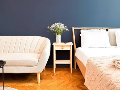 a bedroom with a bed and a chair and a table at Duplex Retreat 2 Studios Balconies, Wi-Fi in Sofia