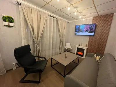 a living room with a couch and a chair and a table at Delight House in Samokov