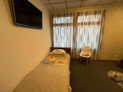 a small bedroom with a bed and a window at Delight House in Samokov
