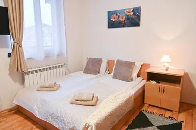 a bedroom with two beds and a window at The Mountain Hug Studio 1 by SI Stay in Bansko