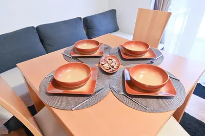 a table with three plates and a bowl of food on it at The Mountain Hug Studio 1 by SI Stay in Bansko