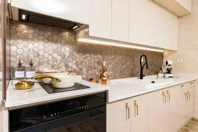 a kitchen with a sink and a stove at Sunny Modern 1BR Retreat with Cozy Balcony in Plovdiv