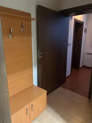 a bathroom with a wooden closet with a wooden door at Kalaydzhiev rooms in Bansko