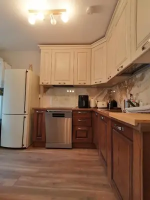 a kitchen with wooden cabinets and a white refrigerator at Iglika 2, A13 & A14 in Borovets