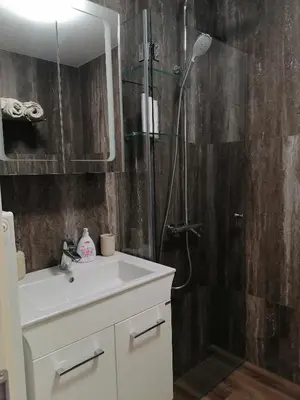 a bathroom with a shower with a sink and a shower at Iglika 2, A13 & A14 in Borovets
