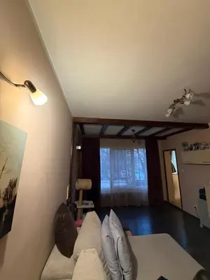 a living room with a couch and a window at Abdovica House in Sofia
