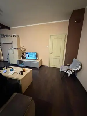 an empty living room with a kitchen and a living room with a couch at Abdovica House in Sofia