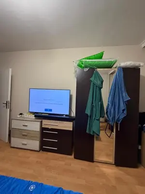 a living room with a tv and a dresser with a tvicterictericter at Abdovica House in Sofia