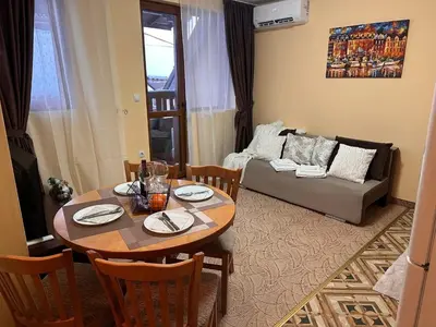 a living room with a table and a couch at Пампорово Mountain Lodge апартамент 46 in Pamporovo