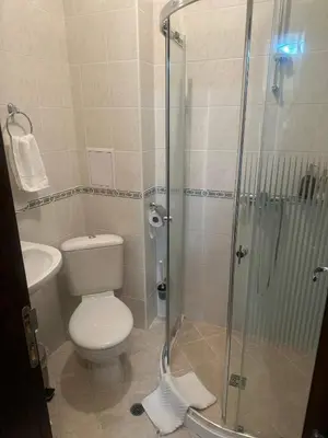 a bathroom with a toilet and a glass shower at Пампорово Mountain Lodge апартамент 46 in Pamporovo