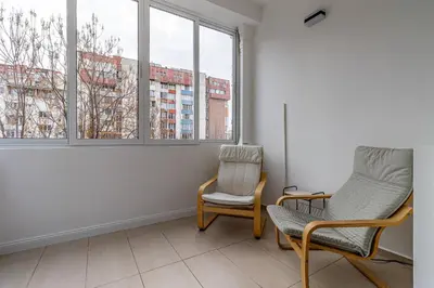 a living room with two chairs and a window at Grand Stamboliyski Residence in Sofia