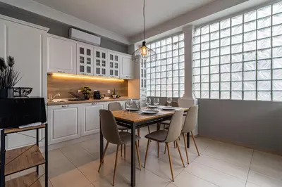 a kitchen with a dining room table and chairs at Grand Stamboliyski Residence in Sofia