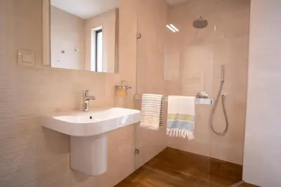 a bathroom with a sink and a shower at Blue Sky Penthouse with Parking Spot and Panorama Views in Sofia