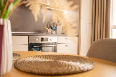 a kitchen with an oven and a table with a plate on it at Blue Sky Penthouse with Parking Spot and Panorama Views in Sofia