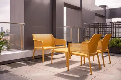 four chairs and a table on a balcony at Blue Sky Penthouse with Parking Spot and Panorama Views in Sofia