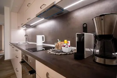 a kitchen with a counter top with a blender at Blue Sky Penthouse with Parking Spot and Panorama Views in Sofia