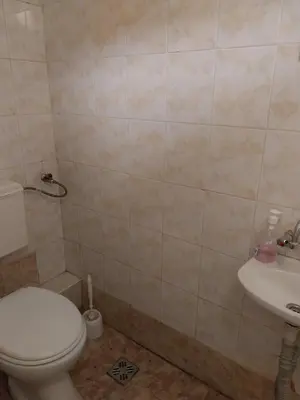 a bathroom with a toilet and a sink at Скай Румс -3 in Sofia