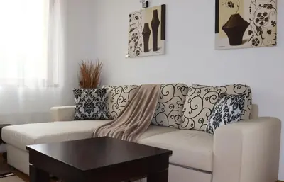 a living room with a white couch and a table at Rila Morning in Borovets