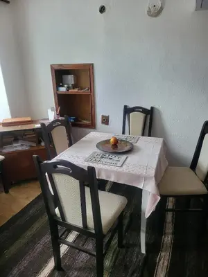 a dining room table with a plate of fruit on it at Cozy house in the heart of Pirin mountain in Razlog
