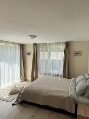 a bedroom with a bed and a large window at The Walnut Nest in Sapareva Banya