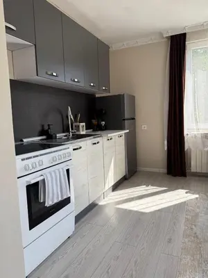 a kitchen with a white stove and a refrigerator at The Walnut Nest in Sapareva Banya