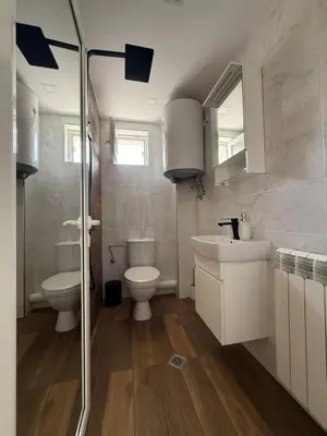a bathroom with a toilet and a sink at The Walnut Nest in Sapareva Banya