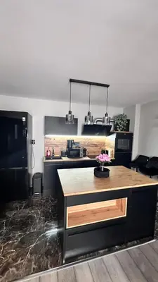 a kitchen with a large island in a room at Апартамент за гости Noa Sift in Velingrad