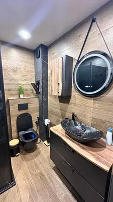 a bathroom with a black sink and a mirror at Апартамент за гости Noa Sift in Velingrad