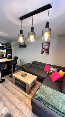 a living room with a couch and a coffee table at Апартамент за гости Noa Sift in Velingrad