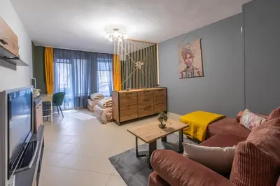 a living room with a couch and a table at Vitoshкa Urban Stay in Sofia