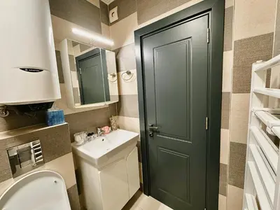 a bathroom with a green door and a sink at Centralside Retreat with Free Parking Spot in Plovdiv